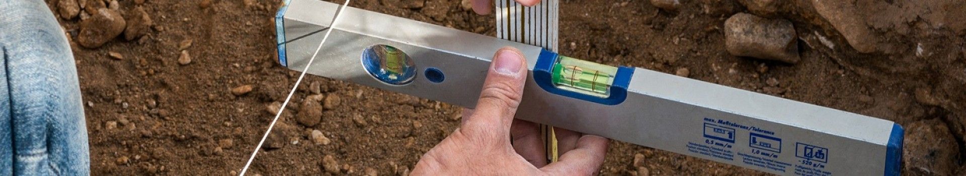 Recording an archaeological feature using a section line and spirit level.