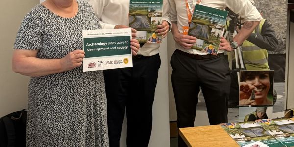 Charlotte Cane MP, CIfA Hon Chair Jim Williams, and CIfA Head of Policy Rob Lennox pose with the published Archaeology and Solar Guide